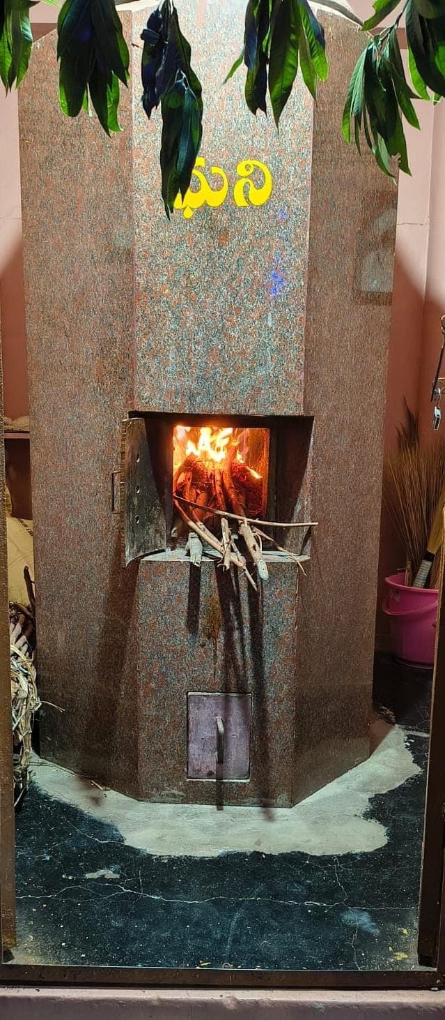 The sacred Dhuni fire burning at the temple